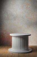White Round Pedestal Display Table on Wooden Floor and Textured Backdrop photo