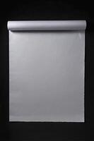 Rolled White Paper Sheet on Black Background for Presentation Mockup photo