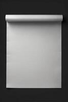 Rolled Paper Backdrop with Gray Surface on Dark Wall Background photo