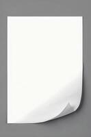 Isolated White Paper with Folded Corner on Gray Background for Mockups photo