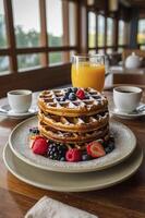 Stack of Waffles Topped with Berries and Powdered Sugar for Breakfast photo