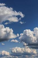 Observing Fluffy White Clouds Floating in a Vivid Blue Sky photo