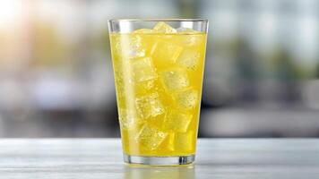 A glass of lemonade with ice cubes on the table photo