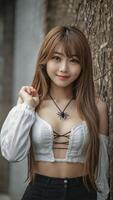 Smiling Asian Woman in White Top Posing by Wall with Vines photo
