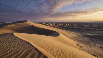 Sand Dunes at Sunset with Textured Surfaces and Dramatic Cloudy Sky photo