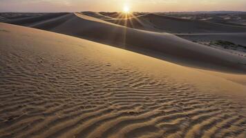 Desert Sand Dunes at Sunset with Sunlight Rays in Peaceful Landscape photo