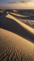 Sand Dune Landscape at Sunrise with Ripples and Warm Golden Light photo