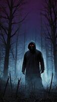 Creepy Hooded Figure Standing in a Dark Misty Forest Scene photo