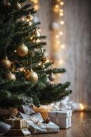 Decorated Christmas Tree with Gifts and String Lights Creating Warm Mood photo
