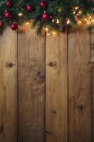 Christmas Decoration with Pine Garland and Red Ornaments on Rustic Wood photo