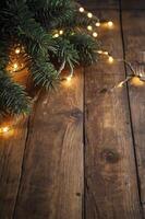 Decorating Rustic Wooden Surface with Christmas Lights and Evergreen Branches photo