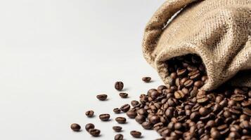 Roasted Coffee Beans Spilling From Burlap Bag on a White Surface photo