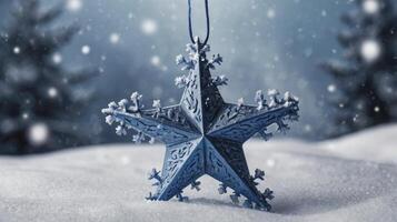 Star Ornament in Snow Falling on Snowy Landscape with Christmas Trees photo