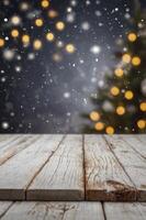 Winter Holiday Background with Snow and Christmas Tree Over Wooden Table photo