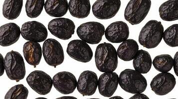 Arrangement of Dark Brown Dates on a Plain White Background photo