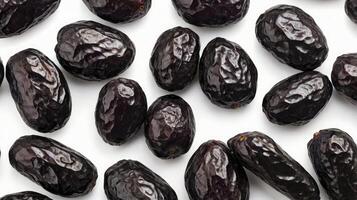 Close Up of Pile of Fresh Black Dates on White Background photo