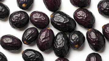 Pile of Fresh Black Olives on White Background Studio Shot photo