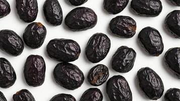 Arrangement of Ajwa Dates on White Background Overhead Shot photo