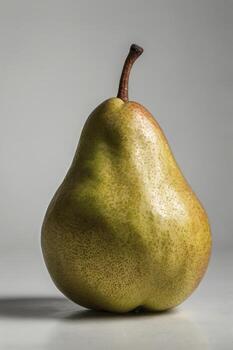 Close-up of Single Green Pear on White Surface in Studio Lighting photo