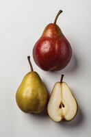 Three Pears Red Yellow and Cut Pear Still Life Arrangement photo