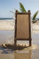 Blank Wooden Sign at Sandy Beach with Ocean Wave Splashing Around photo