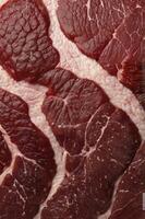Close-up of Fresh Raw Beef Cuts on Fat Layer Background photo