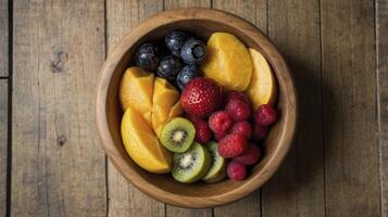 Fruit Bowl with Strawberries, Mango, and Blueberries on Wood Table photo