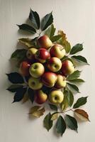 Fresh Apples and Green Leaves Arranged on a Creamy Textured Background photo
