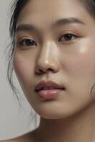Asian Woman Portrait with Radiant Skin and Natural Makeup in Studio photo