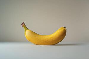 Single Ripe Yellow Banana Isolated on a Simple Background for Food Concepts photo
