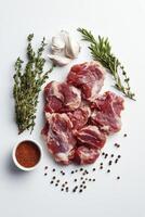 Raw Lamb Chops with Herbs and Spices on a White Background for Cooking photo