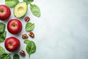 Apples, Avocado, Pecans and Spinach Leaves Flat Lay on Background photo