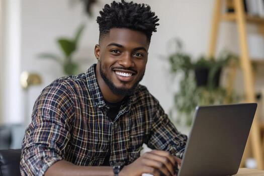 Smiling Man Using Laptop Working From Home with Positive Expression photo