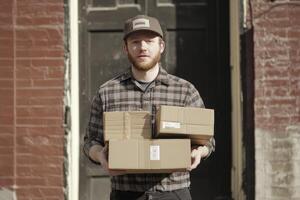Man Holding Boxes Delivering Package Outside Building for Shipping Services photo