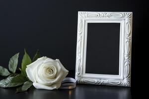 White Rose and Picture Frame on Black Background for Memorial Service photo