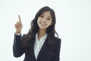 Smiling Business Woman Pointing Upward in Suit Jacket on White Background photo