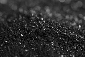 Close-up of Dark Fine Powder Texture with Glimmering Particles Background photo