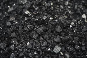 Close-up of Black Salt Crystals Sparkling with Glimmering Light and Shiny Textures photo
