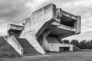 Exploring Brutalist Architecture Concrete Structure and Stairs Under Cloudy Skies photo