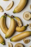 Arrangement of Fresh Yellow Bananas and Banana Slices on a Surface photo