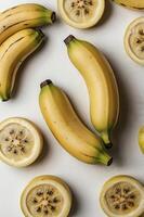 Arrangement of Bananas and Lemon Slices on a Light Surface photo