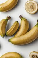 Arrangement of Fresh Bananas and Lemon Slice on White Surface photo