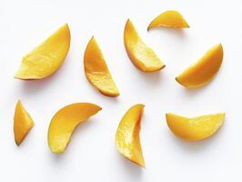 Arrangement of Mango Slices on White Background Overhead View photo