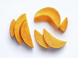 Arrangement of Fresh Sliced Orange Mango Pieces on a White Background photo