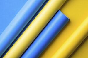 Rolled Colored Papers in Yellow and Blue Showing Textures and Surfaces photo