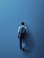 Person Walking Towards Blue Wall with Backpack Minimalist Modern Design photo