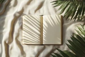 Open Notebook with Palm Leaf Shadows on Beige Fabric Background photo