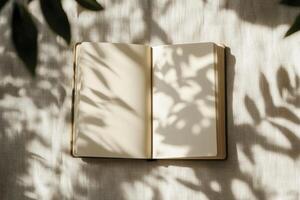 Open Notebook on Linen with Leaf Shadows for Journaling or Planning photo