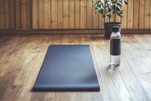 Yoga Mat and Water Bottle Ready for Exercise in Sunlit Room photo