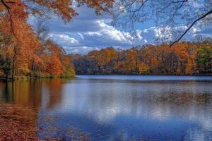 Autumn Lake Reflection with Colorful Fall Foliage and Cloudy Blue Sky photo